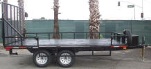 Custom 8 x 14 ATV Trailer with 7,000lb GVWR, Two 3,500lb Axles with One Braking Axle, 1 ½” Square Tubing Frame, 3” 5 on 4 ½ Tires and Wheels, 14” Rail Side Rail with section Folding on Right Side, Painted Trailer Undercarriage, 5/8in D-Rings, Ramp with Spring Assist, Spare tire and Wheel, Spare Mount, Breakaway Kit, 7 Way Plug, Two Stabilizer Stands, E Track on Floor, Box, Winch Plate.
