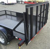 77" x 12' Standard Utility Style Trailer with 7,000lb GVWR, 2 5/16" A Frame Coupler, Equalizer/Leaf Spring Suspension, 15" / 5 on 5 / 4 Ply Tires and Wheels, 2,000lb Jack, 3 x 2 x 3/16 Angle Top Rail, 4" Channel Tongue, Painted Trailer Undercarriage, Electric brakes one axle, breakaway kit, 7 way plug, 2-5/16 coupler, 4' gate, wrap around tongue, 4" drop axles, Z tongue, spring assist both sides of gate, LED flush mount lights, caster wheel, 2" square tube toprail, 1/8" diamond plate floor, 4 - 1/2" D rings, radial tires, 2x4 uprights in ramps at 58" center