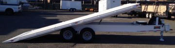 Custom 8'6" x 20' Tilt Bed,9,995lb GVWR, Two 5,200lb Electric Braking Axles, 15” Tires, 5” Frame Channel, 5” Channel Wrap Around Tongue, 2” x 6” Wood Decking with Diamond Plate Tapered End, 12,000lb Drop Leg Jack, 2 5/16” A-Frame Coupler with Safety Chains, Cushion Tilt Cylinder, Breakaway Kit, Deck Over, Spare Tire and Wheel, Spare Tire Mount, Box on Tongue, 10- 1/2" D Rings, Tie Rail, Painted Trailer Undercarriage